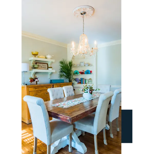 Collins (2) Elegant dining room with a rustic wood table and crystal chandelier