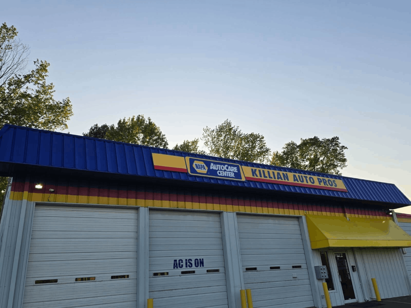 Killian Auto Pros building exterior with blue and yellow awning, showing NAPA Autocare Center sign.