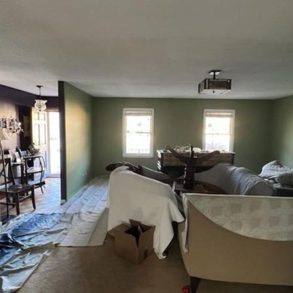 How Much Does it Cost to Paint a Living Room 292 Living room preparation for painting: furniture covered, drop cloths laid.