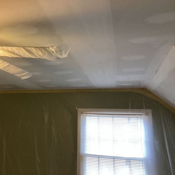 How Much to Paint a Bedroom-image3 Bedroom ceiling being prepped for painting, with plastic sheeting.