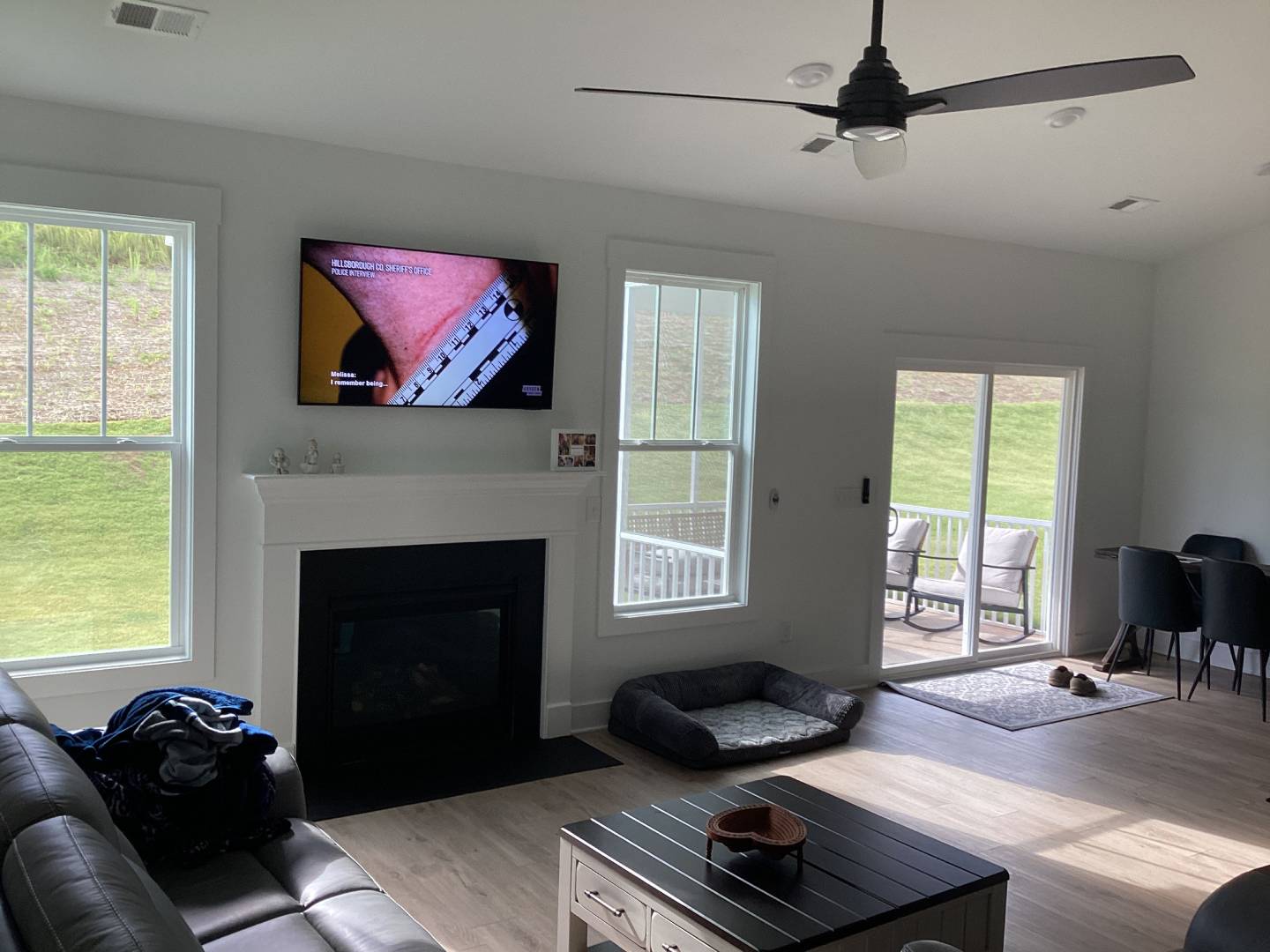 Living room interior with fireplace, TV, and sliding glass doors
