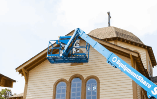 Portfolio 29 Construction worker in boom lift repairing church steeple