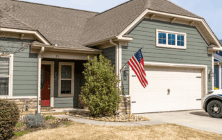 Portfolio 295 Green suburban house with American flag and garage