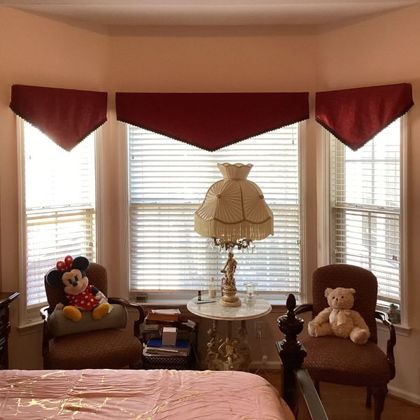 ThingsConsiderBeforeRepaintingHome-4 Bay window with burgundy valances, Minnie Mouse plush, and teddy bear.