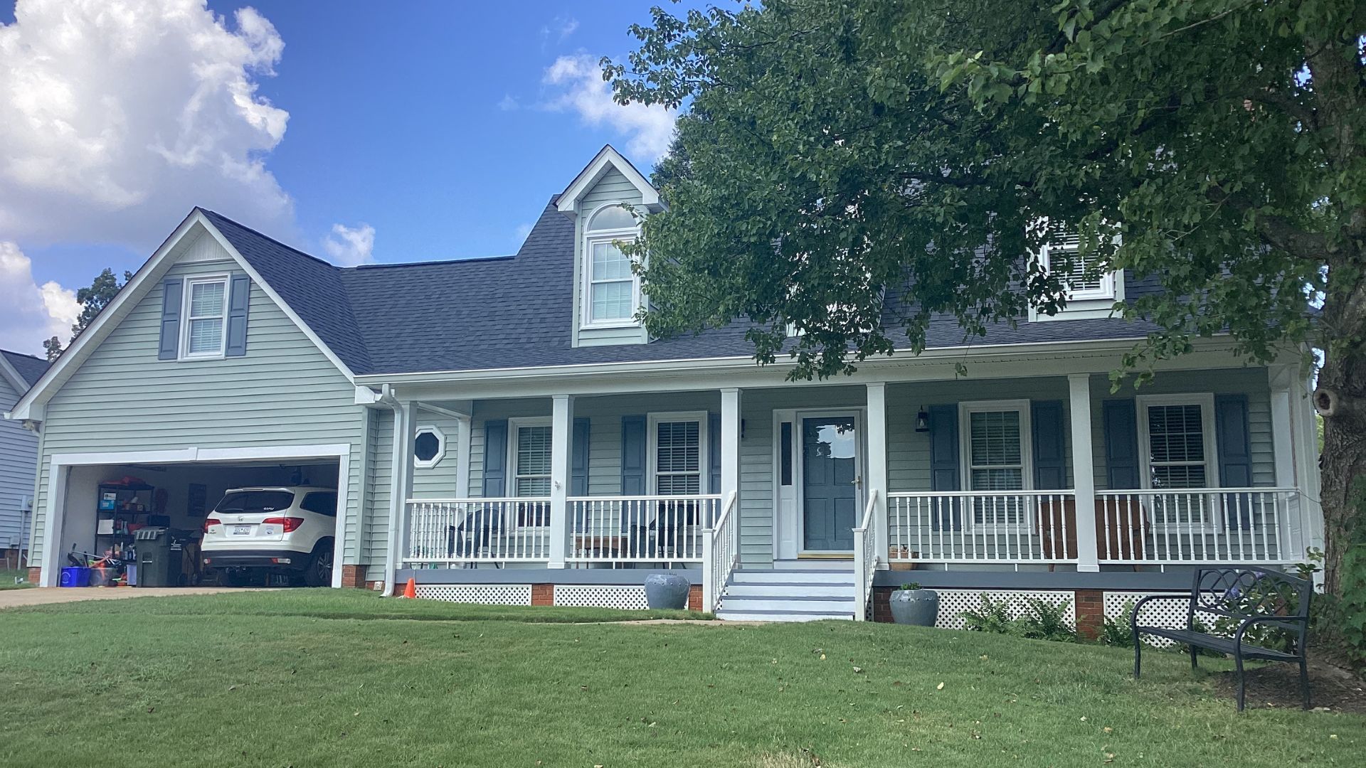 Light blue Hardie board siding on a home with a covered porch.