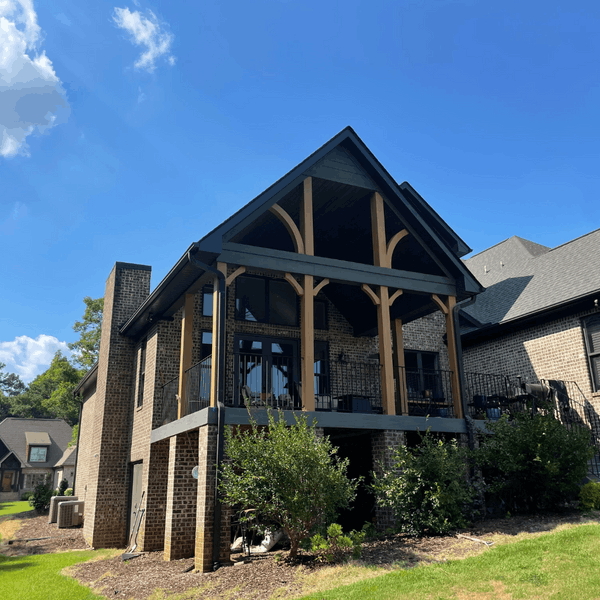 When is The Best Time to Paint My Exterior – 3 Exterior view of a brick house with a covered porch, showcasing paint colors.
