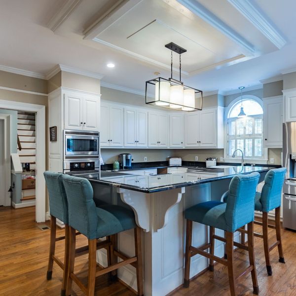 Blue Bar Stools Kitchen Island White Cabinets Modern kitchen with island, white cabinets, and blue bar stools