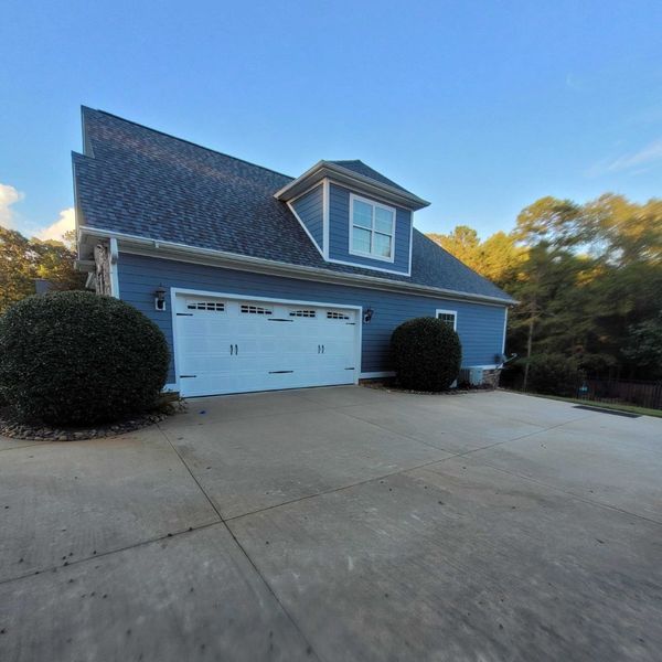 Blue House Two Car Garage With Dormer Regular Maintenance Is Key