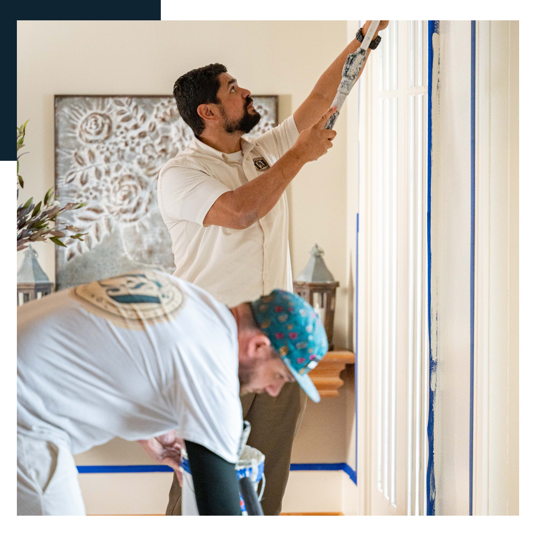 careers2 Painters meticulously tape and paint trim in a home interior.