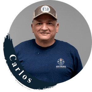 Carlos, a smiling man wearing a SouthEdge hat and navy t-shirt.