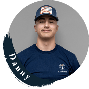 Danny, a South Edge team member, wearing a navy blue t-shirt and cap.
