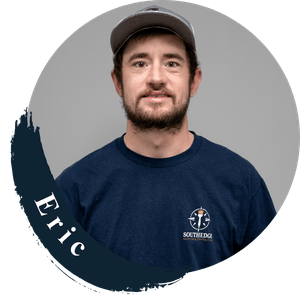 Eric, a team member from Southridge, wearing a navy blue t-shirt and a baseball cap.