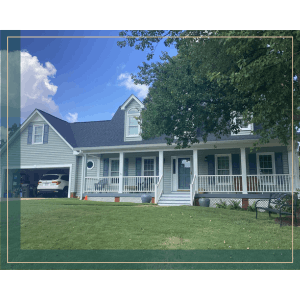 Light blue siding house with white porch and attached garage, showing exterior pricing.
