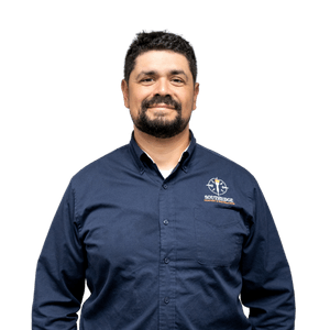 Man Wearing Blue Collared Shirt With Logo Southbridge company employee wearing a navy blue button-down shirt
