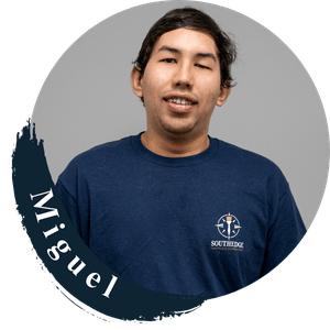Miguel, a young man wearing a Southridge t-shirt, smiles.