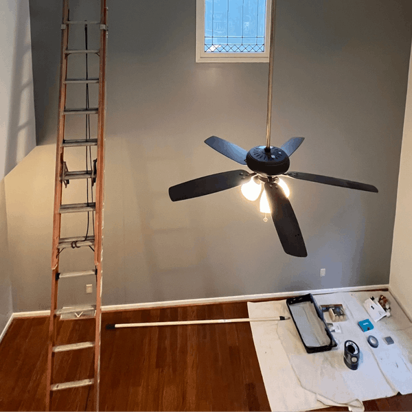 Painting Ladder And Fan In Room Preparing for Exterior House Painting.