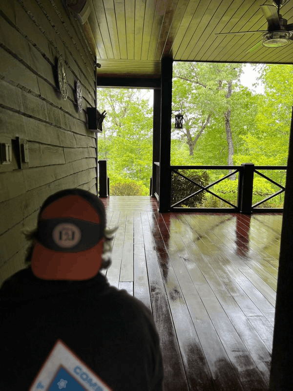Person On Wet Wood Porch Overlooking Green Trees Trusted painting experts