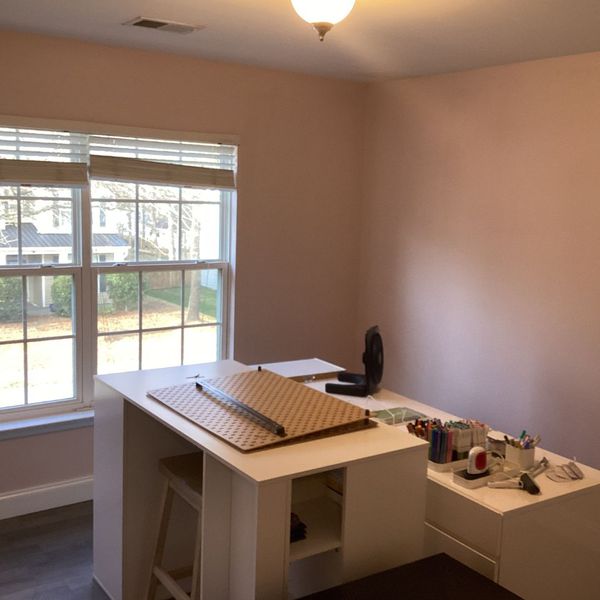prepare your space Crafting table with art supplies near a window, ready for painting.