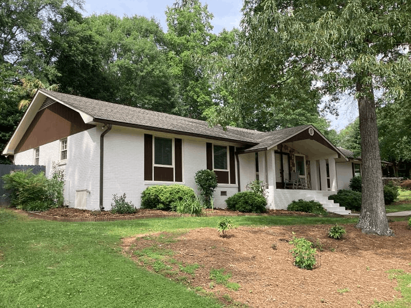 White Brick Ranch House With Brown Accents White brick ranch home with brown trim in Spartanburg County, SC