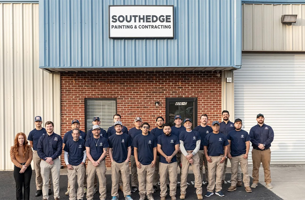 Southedge Painting & Contracting team standing outside the company building beneath its sign.