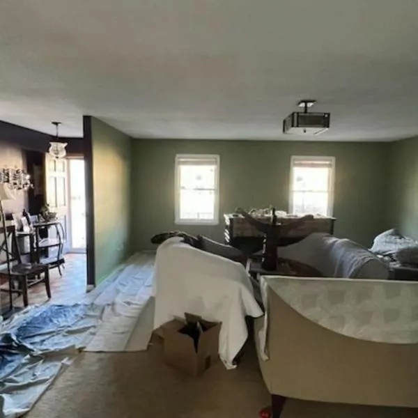 How Much Does it Cost to Paint a Living Room 292 Living room preparation for painting: furniture covered, drop cloths laid.